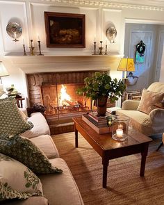 a living room filled with furniture and a fire place next to a fireplace covered in candles