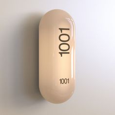 a pill with the word toot on it is hanging up against a white wall