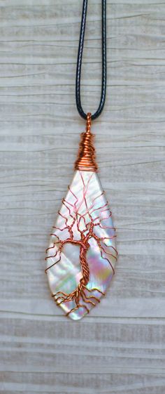 a wire wrapped pendant with a tree on it