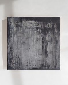 a black and white painting hanging on the wall