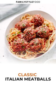 a white bowl filled with spaghetti and meatballs