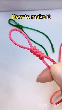 someone is holding a pink and green string with the words how to make it written on it