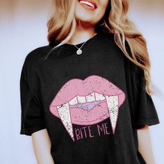 Distressed Bite Me T-shirt, Bite Me Shirt for Halloween, Shirt for Vampire, Halloween T-shirt, Aesthetic Halloween Shirt, Vampire Shirt *These comfy unisex shirts are PERFECT by themselves or layered with your favorite cardigan! <3 *The soft-washed, garment-dyed fabric brings extra coziness to your wardrobe while the relaxed fit makes it an excellent daily choice. The double-needle stitching throughout the tee makes it highly durable while the lack of side-seams helps the shirt retain its tubular shape. *Details: .: 100% ring-spun cotton .: Medium fabric (6.1 oz/yd² (206.8 g/m .: Relaxed fit .: Sewn-in twill label .: Select true size for a little extra room for styling; or size up 1-3 sizes for an ultra cozy/oversized look *Unfortunately, we do not accept exchanges, cancellations, or retur Edgy Halloween T-shirt For Alternative Fashion, Edgy Halloween Graphic Print Tops, Casual Tops For Halloween Alternative Fashion, Casual Tops For Halloween, Edgy Halloween T-shirt With Screen Print, Edgy Short Sleeve Halloween Tops, Gothic Short Sleeve T-shirt For Halloween, Edgy Short Sleeve T-shirt With Funny Print, Edgy Cotton Tops For Halloween