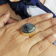 Made In India, Make the season's greeting a memorable one with this 18k gold plated brass single oval gemstone ring. Handmade with high quality labradorite, this simple everyday ring will make Christmas a day to remember.Natural Labradorite Ring, Yellow Gold Plated Ring, Polished Gemstone Ring, Statement Ring, Bezel Set Ring, Oval Shape Ring, Gift For WomenProduct DetailsItem Code: IAJBR-0135Gross Wt. 7.30 GmsStone Name: LabradoriteStone Shape : OvalStone Dimension : 16*22mmMetal: 18K Yellow Gol Adjustable Oval Emerald Ring For Gift, Oval Natural Stone Rings For Anniversary, Oval Gemstone Ring For Memorial, Oval Rings With Natural Stones For Anniversary, Oval Natural Stones Anniversary Rings, Oval Shape Ring, Bezel Set Ring, Ring Bezel, Everyday Ring