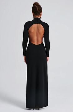 Say hello to Imelda. your new fave black dress to wear everywhere. This super sexy. versatile maxi is cut with sleek long sleeves. high neck and eye-catching low open back. It's finished with a thigh high split and boning for added structure. Style yours with black mule heels and a chic hair up.   Colour: Black. Premium stretch crepe fabric. Fully lined. High neck with buttons on back neck. Long fitted sleeves. Boning on side for added structure. Moulds to figure with bodycon fit. Thigh high split. Low open back. Maxi length. Model is an XS and is wearing an XS. Luxury Evening Maxi Dress With Cutout Back, Luxury Maxi Dress With Side Slits And Asymmetrical Neckline, Luxury Backless Dress With Cutout Back, Luxury Evening Backless Dress With Cutout Back, Luxury Maxi Dress With Asymmetrical Neckline And Side Slits, Luxury Low Back Maxi Dress For Evening, Luxury Evening Backless Dress With Back Zipper, Luxury Sleek Maxi Backless Dress, Luxury Low Back Maxi Evening Dress