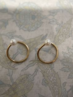 Minimalist Yellow Gold Pearl Hoop Earrings, Minimalist Yellow Gold Small Hoop Pearl Earrings, Minimalist Small Hoop Yellow Gold Pearl Earrings, 14k Gold Round Single Pearl Stud Earring, Single Round 14k Gold Pearl Earring, Minimalist Small Hoop Pearl Earrings For Anniversary, 14k Gold Round Earrings With A Modern Twist, Modern Twist 14k Gold Round Earrings, Solid Gold