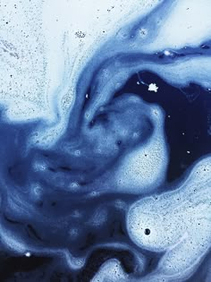 blue and white liquid swirling in the air