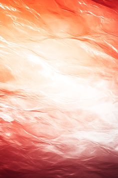 an orange, red and white background with waves