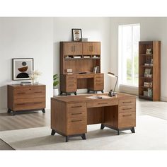 a wooden desk sitting in the middle of a room