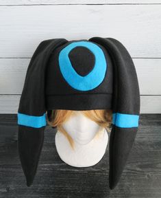 These hats are made from fleece and interfacing in the ears but still have floppiness to them and do not stand up (sorry but I do not offer this option). ⫸ Perfect for: fans, cold weather, costumes, or conventions. Very warm! ⫸ Size: Fits anyone age 5+, one size fits most. Circumference about 24-25 in.⫸ Care instructions: I recommend hand wash but should be fine in machine wash cold.All hats are made in a smoke-free, pet-free environment. All hats are made with a sewing machine. Patterns and des Adjustable Felt Hat For Winter Costume, Adjustable Hats For Winter Costume, Adjustable Winter Hats For Costume Events, Black Hat For Cosplay, One Size Fits Most, Black Cosplay Hat, One Size Fits Most, Adjustable Black Hat With Ears, Black Cosplay Hat One Size Fits Most, Adjustable Felt Costume Hat For Winter, Adjustable Felt Costume Hats And Headpieces For Winter