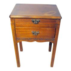 a small wooden table with two drawers on one side and an open drawer on the other