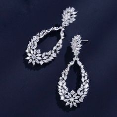 Bold and beautiful, this pair of bridal earrings will add a touch of sophistication to any wedding gown or formal ensemble. Adorned with flawlessly faceted cubic zirconia that capture the light in a dazzling array of sparkles, the earrings are rhodium/rose gold plated for a bright finish which enhances the intricate detailing and conveys a modern take on old elegance. Length: 2.5" (approx. 6.3cm). Width: 1" (approx. 2.5cm). Weight: 10g. Available in Silver and Rose Gold finishes. To make your ch Cubic Zirconia Bridal Earrings, Silver Bridal Earrings, Sleek Updo, Soft Waves, Bold And Beautiful, Wedding Trends, Bridal Earrings, Wedding Gown, Rose Gold Plates