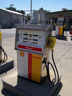 a gas pump sitting on top of a cement slab