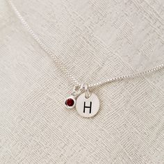 "January Birthstone Initial Necklace, Garnet Jewelry, January Birthday Gift, January Birthstone Jewelry,Personalized, Sterling Silver Garnet Lovely January Birthstone Garnet Necklace. For babies born in January, the garnet is the perfect gem to represent their birthstone. This beautiful stone, which is most commonly red but can be found in a range of other colors, symbolizes peace, prosperity and good health. Some say it even has the power to give the wearer eternal happiness, health and wealth. Red Initial Pendant Jewelry Gift, Red Initial Pendant Jewelry As A Gift, Red Initial Pendant Jewelry For Gift, Valentine's Day Birthday Birthstone Necklace, Birthstone Necklace For Birthday And Valentine's Day, Round Birthstone Necklace With Charms For Birthday, Silver Birthstone Necklace With Gemstone Initial Pendant, Charm Birthstone Necklace For Birthday Gift, Round Charms Birthstone Necklace Birthday Gift