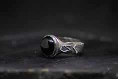 "Archangel ring. // Black onyx, sterling silver. Features the sigils of the archangels Raphael, Michael, Gabriel, and Uriel, set with a 12mm black onyx. The word archangel derives from the Greek ἀρχάγγελος, meaning \"chief angel\", or \"angel of origin.\" The archangel Michael appears in the Bible depicted as having \"the voice of the archangel, with the trumpet call of God\" and is referred to as one of the \"chief princes\". Personified as angels to man, they are the first executors of the div Mystical Black Sterling Silver Rings, Black Sterling Silver Hand Forged Jewelry, Black Hand Forged Sterling Silver Jewelry, Hand Forged Black Sterling Silver Jewelry, Formal Black Hand Forged Jewelry, Formal Hand Forged Black Jewelry, Symbolic Black Rings With Oxidized Finish, Symbolic Hand Forged Black Jewelry, Symbolic Hand-forged Black Jewelry