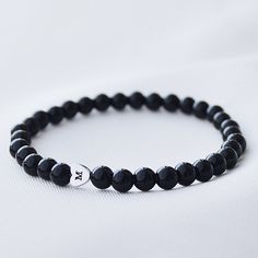 "Handmade tiny beaded bracelet with engravable heart. D E T A I L S - 6mm black stone beads - Engravable hematite bead (up to 3 letters) - Doesn't tarnish over time S I Z E This bracelet is made on a stretch cord and comes in 4 different wrist sizes (when measured tightly) : S | 14 - 15 cm | 5.5″ - 5.9″ M | 15 - 16 cm | 5.9\" - 6.3\" L | 16 - 17 cm | 6.3\" - 6.7\" XL | 17 - 18 cm | 6.7\" - 7\" * If you need custom size, just let me know and I will make it for you.  P A C K A G I N G  - Sent in a velvet bag, or can be gift wrapped in branded gift box  S H I P P I N G The order will be sent out within 3 working days, please let us know if you want it sooner. F O L L O W  U S Instagram @lovein.lt" Personalized Black Minimalist Beaded Bracelets, Personalized Minimalist Black Beaded Bracelets, Minimalist Adjustable Black Name Bracelet, Minimalist Personalized Black Beaded Bracelets, Black Minimalist Name Bracelet As Gift, Black Minimalist Name Bracelet For Gift, Minimalist Black Name Bracelet Gift, Minimalist Black Name Bracelet, Black Bracelets With Letter Beads For Everyday