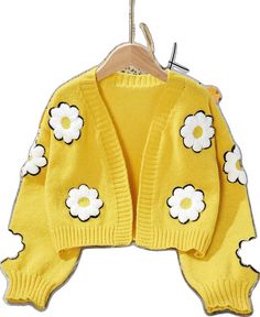 Playful Knitted Sweater For Spring, Playful Knitted Spring Sweater, Playful Spring Knitted Sweater, Cute White Winter Cardigan, Playful White Winter Cardigan, Cute Knitted Spring Outerwear, Yellow Knitted Cardigan For Spring, Spring Yellow Knitted Cardigan, Cute Yellow Long Sleeve Sweater