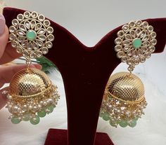 Beautiful Medium Gold Plated Jhumki | Jhumka | Perfect for Wedding , Party wear | Indian, Pakistani, Desi wedding |Holiday Gifting, Gift for her. Lightweighted Jhumka available in 3 colors. - Mint - Pink - Blue Care: It is advisable that you keep our products away from direct heat, humidity, and moisture.Please do not use Perfume on the products. Please Follow us on Instagram: https://instagram.com/krishmadesigns?utm_medium=copy_link Note: Free Shipping over $75. Contact us for any question! Party Eid Jhumkas With Tilla Detail, Eid Party Jhumkas With Cutdana Detail, Eid Party Jhumkas With Cutdana, Festive Party Jhumkas, Green Tilla Jhumkas For Party, Festive Party Jhumkas With Latkans, Wedding Chandbali Jhumkas With Dori Work, Festival Party Cutdana Jhumkas, Wedding Jhumkas With Zari Work For Navratri