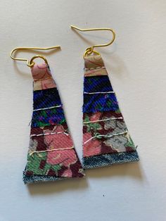 two pairs of earrings made out of fabric with gold earwires hanging from them