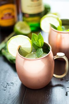 two copper mugs filled with mint and lime