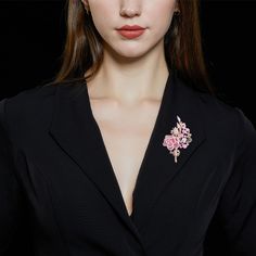 This captivating piece is a celebration of the timeless beauty of roses, brought to life with an array of dazzling stones. The brooch features a delicate rose blossom for a touch of its natural allure. Adjacent to the flower, each gracefully curved leaf adds a touch of organic charm to the design. All of the elements are adorned with an abundance of shimmering stones, carefully selected to enhance their inherent beauty. This versatile accessory can be worn on a lapel, a scarf, or as a centerpiec Elegant Rose Design Brooch, Luxury Pink Brooches For Wedding, Luxury Pink Brooch For Wedding, Luxury Pink Wedding Brooches, Elegant Rose Gold Party Brooches, Elegant Rose Brooches, Elegant Pink Flower Brooch, Elegant Rose-colored Brooches, Elegant Formal Rose Design Brooches