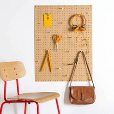 a wall mounted pegboard with scissors and other items on it