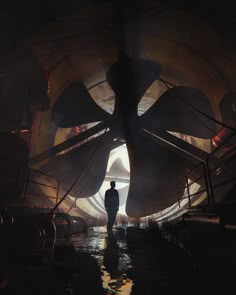 a man standing in the middle of a tunnel