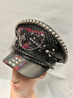 This is a black leatherette captain hat. Well made to a high standard. It has plenty of eye catching detail including metal studs, safety pins , please refer to photos . This is a size 59 cm which fits most size heads. No two hats are created the same. Individual and unique  Thank you for looking Adjustable Punk Costume Hats And Headpieces For Cosplay, Black Punk Costume Hats And Headpieces, Punk Style Adjustable Costume Hats For Cosplay, Punk Winter Hat For Festivals, Punk Style Winter Hats For Festival, Winter Festival Punk Style Hat, Edgy Black Hat For Alternative Fashion, Black Alternative Style Hats For Alternative Fashion, Adjustable Punk Visor Hat