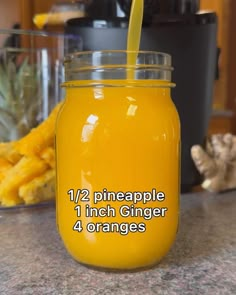 a mason jar filled with orange juice on top of a counter