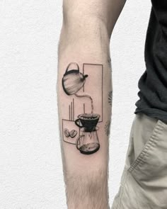 a man's arm with a coffee pot and kettle tattoo on the left forearm