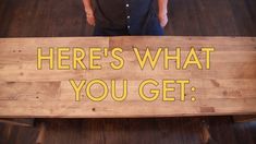 a man standing next to a wooden sign that says here's what you get