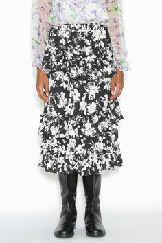 Step into sophistication with our Silk Print Black White Ruffle Layer Skirt. The exquisite painting floral pattern adds an artistic touch, while the lined interior ensures comfort and coverage. This skirt effortlessly combines style and grace, making every step an elegant statement. Embrace the allure of silk, the timeless appeal of black and white, and the charm of ruffle layers—all in one stunning piece. Elevate your wardrobe with this versatile and enchanting skirt that seamlessly transitions Layer Skirt, Holiday Glam, American Fashion Designers, Painting Floral, Layered Skirt, Style And Grace, Vanuatu, Zambia, Floral Painting