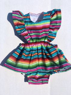 Perfect for all the summer 🥳 FIESTAS!! Handmade skirt romper. Made with cotton serape cotton fabric. These amazing pieces are made to order. Sizes 0-6 month up to 4T are made with attached bloomers and snaps at the saddle. Anything above a 4t (5t -7/8y) are the same style dress with no bloomers attached. If you have any questions on sizing please don't hesitate to message me. I will gladly help. Summer Twirl Dress With Ruffles For Playtime, Multicolor Short Sleeve Twirl Dress With Ruffles, Multicolor Twirl Dress With Ruffles And Short Sleeves, Rainbow Cotton Dress For Playtime, Rainbow Cotton Playtime Dress, Multicolor Short Sleeve Twirl Dress For Summer, Fun Rainbow Dress For Playtime, Cotton Ruffle Dress For Festivals, Summer Beach Twirl Dress With Ruffles