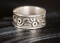 This is a wide chunky silver ring in a single copy. The image is abstract and inspired, without being tied to a specific style, here you can find something from Indians and Scythians at the same time, something from my head, an abstraction. the ring is suitable for both men and women, as well as many works from our collection. The width of the ring is 0.39 inches. Why should you buy a jewelry in my shop? -free woldwide shipping -high-quality - unique author's design -the uniqueness and individuality that you will feel wearing our jewelry -love in every product Order procrssing usually takes 1-3 business How to order: 1.select jewelry. 2. click ADD TO CART. For multiple items go back to the listing and repeat the steps. If you have a problem with your order, please contact us before leaving Unique Thick Band Jewelry Gift, Sterling Silver Rings With Thick Band, Sterling Silver Rings With Thick Band, Stamped 925, Sterling Silver Ring With Thick Band Stamped 925, Sterling Silver Rings With Stamped 925 And Thick Band, Unique Open Band Sterling Silver Jewelry, Handmade Sterling Silver Wide Band Promise Ring, Symbolic Hand Forged Ring Jewelry, Sterling Silver Wide Band Promise Ring