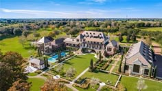 an aerial view of a large mansion with a pool