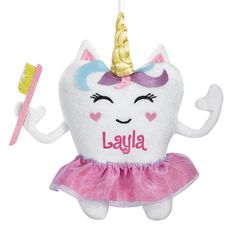 a stuffed animal with a toothbrush in it's mouth and a name on the front