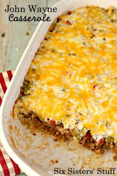 a casserole dish with meat and cheese in it on a red and white napkin