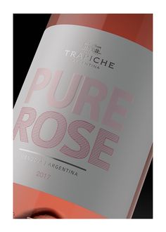 a bottle of wine that is sitting on a black surface with the words pure rose in it