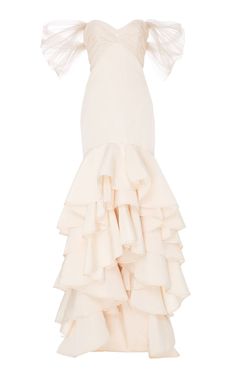 a white dress with ruffles on the bottom