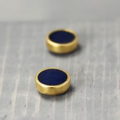 These lapis lazuili earrings have a color that look like it was stolen right out of the night sky. * 8.2mm Pewter plated earrings with 14k gold * Crushed Chyrsocolla stone is mixed with epoxy & cured. * Final finish is glossy and not rough. Lapis Lazuli is one of the most sought after stones in use since man's history began. Its deep, celestial blue remains the symbol of royalty and honor, gods and power, spirit and vision. It thought to be a universal symbol of wisdom and truth. Lapis Lazul Minimalist Blue Brass Earrings, Blue Minimalist Brass Jewelry, Minimalist Blue Brass Jewelry, Brow Chakra, Chakra Earrings, Casper Wyoming, Gold Galaxy, Mountain Earrings, Pewter Plates