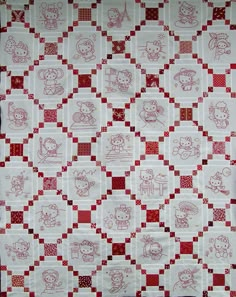 a red and white checkered quilt with teddy bears on the front, in squares