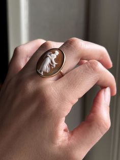 A stunning, bezel set cameo conversion ring featuring a side-facing figure among the gossamer billows of a greco-roman gown. English. This lovely conversion is set in 9k gold, circa 1890. Materials & Features: 9k Gold Age/Origin: English, 1890 Measurements: 1.25” north-south, 4.38g, Size 7.75 Condition: Excellent condition. Minor associated age wear. Please view and inspect any photos closely. We endeavor to fully disclose all condition information clearly and concisely, however, please note tha Roman Gown, Cameo Earrings, Historical Jewellery, Greco Roman, Cameo Jewelry, Cameo Ring, Cameo Necklace, North South, Earrings Rings