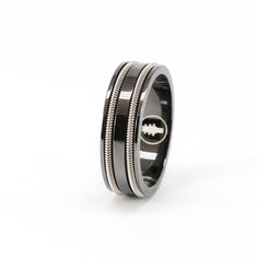 Designed to transform through everyday wear, Heartstrings' Black Guitar String Ring features a black rhodium plating over a sterling silver ring wound with your choice of one or two strands of electric nickel guitar strings. The black plating gradually thins over time, presenting as a patina that allows the silver undertones to shine through. Heartstrings' eco-friendly promise delivers jewelry and packaging that transform end-of-life materials into beauty for even the most discerning. Guitar String Ring, Guitar Ring, String Ring, Guitar String Jewelry, Black Guitar, Electric Guitar Strings, Heart Strings, Guitar Strings, Block Lettering