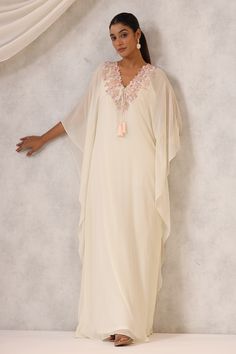 Off white kaftan crafted in georgette featuring floral sequin and bead embroidered neckline with a front tie-up detail. Includes an inner lining and has asymmetric sleeves., Fit: Relaxed