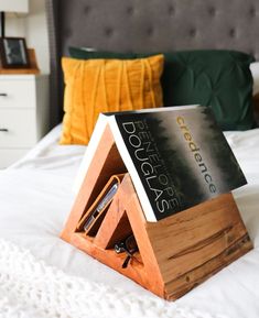 a book stand sitting on top of a bed