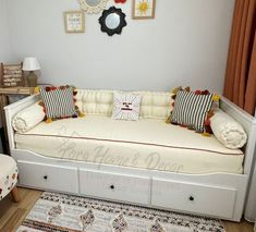 a white day bed with lots of pillows on it