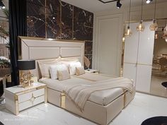 a bed room with a neatly made bed next to a night stand and two lamps