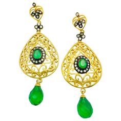 The handmade filigree faux emerald green earrings is ornate and lovely, it is further enhanced by sparkling CZ stones. Earrings have a post closure for pierced ears. Length: 2 3/4 inches Width: 1 1/2 inches Green Luxury Pierced Earrings, Luxury Green Pierced Earrings, Green Luxury Earrings, Elegant Green Chandelier Earrings With Intricate Design, Ornate Green Jewelry With Intricate Design, Green Jeweled Earrings For Celebration, Green Chandelier Earrings With Intricate Design For Festive Occasions, Green Intricate Design Dangle Earrings, Green Dangle Earrings With Intricate Design