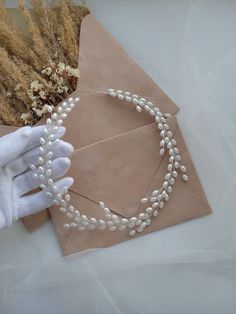 Enchant your bridal look with timeless elegance using our pearl headband. This minimalistic yet captivating headpiece embodies a light, romantic allure, perfect for the modern bride seeking understated sophistication. Handcrafted to perfection, our high-quality bridal hair piece exudes delicate charm, featuring meticulously placed pearls that gracefully adorn the 16-inch length of this exquisite piece. Its minimalist design effortlessly complements any bridal hairstyle, adding a touch of refined glamour to your ensemble. Embrace the essence of simplicity and grace on your special day with our wedding headband, the epitome of understated beauty and exquisite craftsmanship ◦ Customize your perfect accessory! Handcrafted with care, our accessories are crafted with attention to detail and qual Headband Bridal Hair, Headband Pearl, Hair Accessories Bridal, Headband Bridal, Bridal Hair Piece, Headband Wedding, Bridal Hairstyle, Bridal Hair Vine, Hair Jewelry Wedding