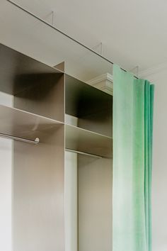 a bathroom with a green curtain hanging from the ceiling